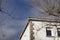 Building. White colored building next to some bare and leafless trees in the surroundings.