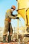 Building worker pouring concrete with barrel