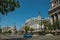 Buildings on the busy street with people and cars in Madrid