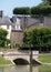 Buildings at Chateau de Villandry in the Loire Valley, France, with water and bridge in the foreground.