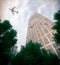 Buildings with flying airplane and trees concept business and tourism background