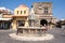 Buildings and fountain in square houses of the locals and narrow streets.