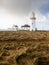 Buildings and Loop head Lighthouse in county Clare, Ireland. Popular travel landmark and sightseeing area. Cloudy sky. Irish