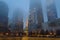 Buildings in Lower Manhattan Fading into the Fog. New York City Freedom Tower and other Skyscrapers on a Foggy Night