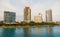 Buildings of miami, usa on sea shore. Building houses on cloudy sky