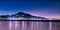 Buildings near the mountains reflected in the lake under the starry sky in Tamsui District, Taiwan