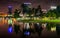 Buildings and palm trees reflecting in Lake Eola at night, Orlando, Florida.