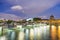 Buildings of Paris around Louvre complex with Seine river at night, France