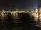 Buildings of Paris around Louvre complex with Seine river at night, France.