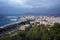 Buildings, port, bay, ships against a cloudy sky. Dramatic sky over the city. Beautiful view