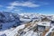 Buildings and railroad tracks with majestic snowcapped mountains