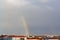 Buildings and rainbow on sky