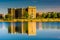 Buildings reflecting in Druid Lake, at Druid Hill Park in Baltimore, Maryland.