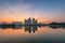 Buildings with reflections on lake at sunset at An Binh City, Hanoi