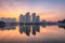 Buildings with reflections on lake at sunset at An Binh City, Hanoi