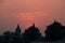 Buildings silhouette at sunset in India. Red orange purple colorful sky. Travel concept. Orchha temple complex.