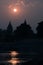 Buildings silhouette at sunset in India. Sun reflection on river. Travel concept. Orchha temple complex.