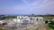 Buildings under construction on background of sea. Clip. Top view of panorama of buildings under construction on