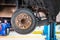 Buildup of rust on rear brake rotors cover on a car lift in garage