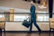 Buisnessman in a blue suit holding a suitcase walking fast