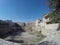 Bukhara. A dry old drinking pond and buildings around,