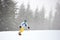 Bukovel, Ukraine - December 09, 2018: male snowboarder in ski mask freeriding on snow-covered mountain slope in snowfall