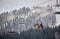 Bukovel, Ukraine - December 09, 2018: skiers and snowboarders sitting carrying high up on cable chairlift in Carpathians