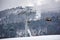Bukovel, Ukraine - December 09, 2018: skiers and snowboarders sitting carrying high up on cable chairlift in Carpathians