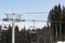 BUKOVEL, UKRAINE - FEBRUARY 28, 2018 Side view of the gray chairlift tower in the ski resort Bukovel, Ukraine