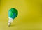 Bulb decorated as plasticine Earth planet model on yellow background