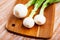 Bulb, white onions with tops closeup on table