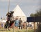Bulgar, Russian Federation - August 2018, - a man in armor rides a horse in fair, the horse raises its front hooves