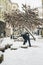 Bulgaria, circa February 2021: A person cleaning snow of a street in Sofia, Bulgaria. Cold winter weather in Europe.