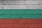 Bulgaria flag depicted in bright paint colors on old wooden wall. Textured banner on rough background