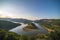 Bulgaria, Kardzhali dam, panoramic view of meander in Arda river, surrounded with green forest, summer time during sunset