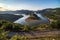 Bulgaria, Kardzhali dam, panoramic view of meander in Arda river, surrounded with green forest, summer time during sunset