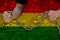 Bulgariamale hands break iron chain, symbol of bondage, protest against background of national flag of bolivia, concept of
