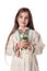 Bulgarian girl in traditional folklore costumes with spring flowers snowdrop and handcraft wool bracelet martenitsa symbol of Baba