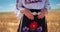 Bulgarian girl wearing traditional ethnic bulgarian costume embroideries and ancient folk belt buckle on wheat field, Bulgaria