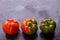 Bulgarian pepper, orange and green, on a black background.