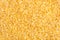 Bulgur cereal texture background. Top view, closeup.