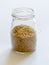 Bulgur grains neatly stored in a glass jar against a clean white background, illustrating food storage