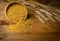 Bulgur Heap Scattered from Wooden Bowl on Wood Background