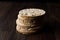 Bulgur Rice Cake Crackers Round Shaped on Dark Wooden Surface.