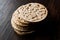 Bulgur Rice Cake Crackers Round Shaped on Dark Wooden Surface.