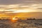 Bulk cargo ships for import export cargo anchored at the offshore sea horizon in the evening with a golden sunset