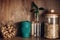 Bulk store shopping. Glass jar with cereals, bowl with nuts, reusable coffee cup and bamboo leaves on wooden shelf. Zero waste