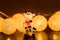 Bull with coins on the background of a yellow garland. Statuette of a cow on a dark background. Christmas, new year 2021. Symbol o