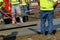 Bull float being used on a freshly poured sidewalk