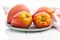 Bull heart tomatoes on plate on white table